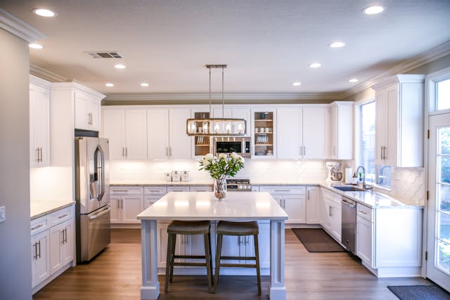 Furnished kitchen with a vase of flowers on the island